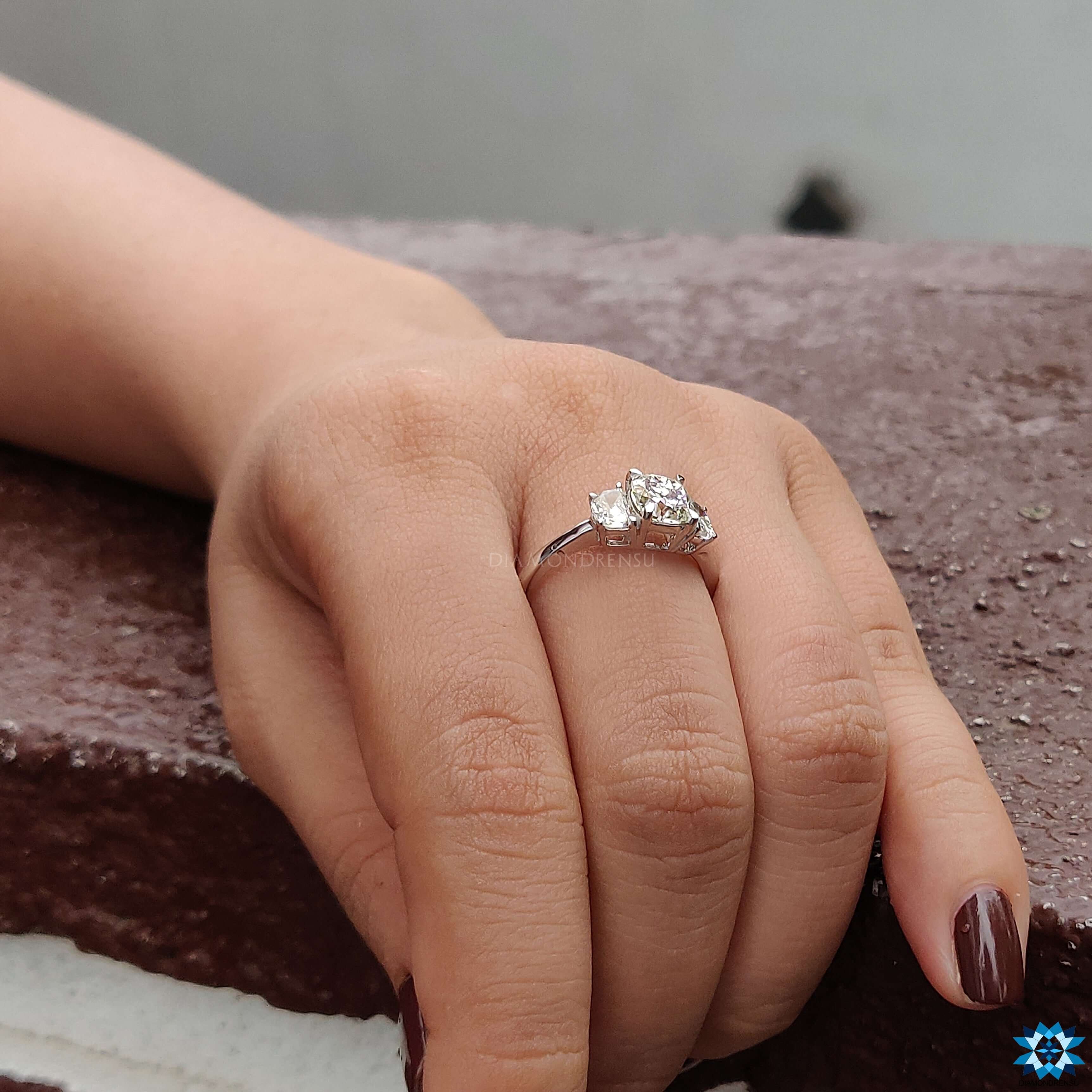 Custom ring with a cushion cut ring and elegant side stone detailing.