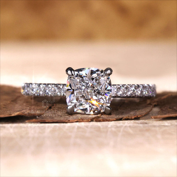 Cushion cut ring diamond with a unique pave band engagement ring style, perfect for modern brides.
