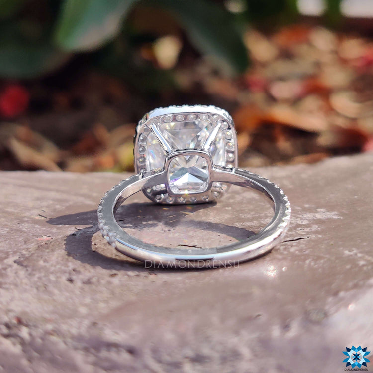 White gold engagement ring with cushion moissanite.
