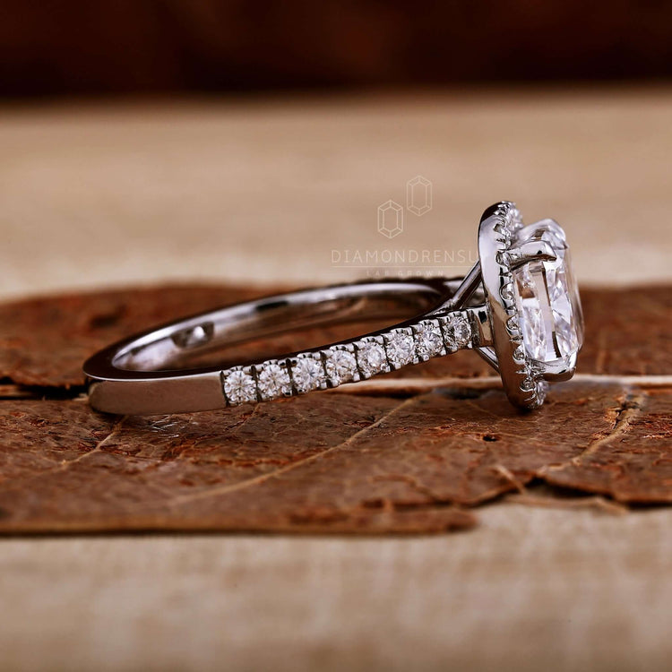 Halo ring with a stunning cushion cut ring diamond for timeless beauty.
