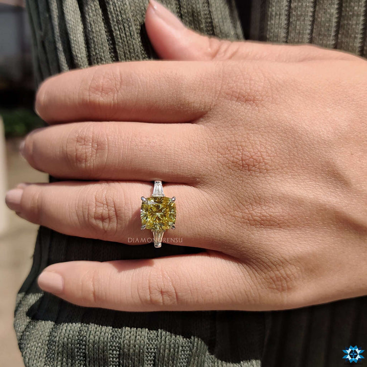 Three stone cushion cut ring in white gold.
