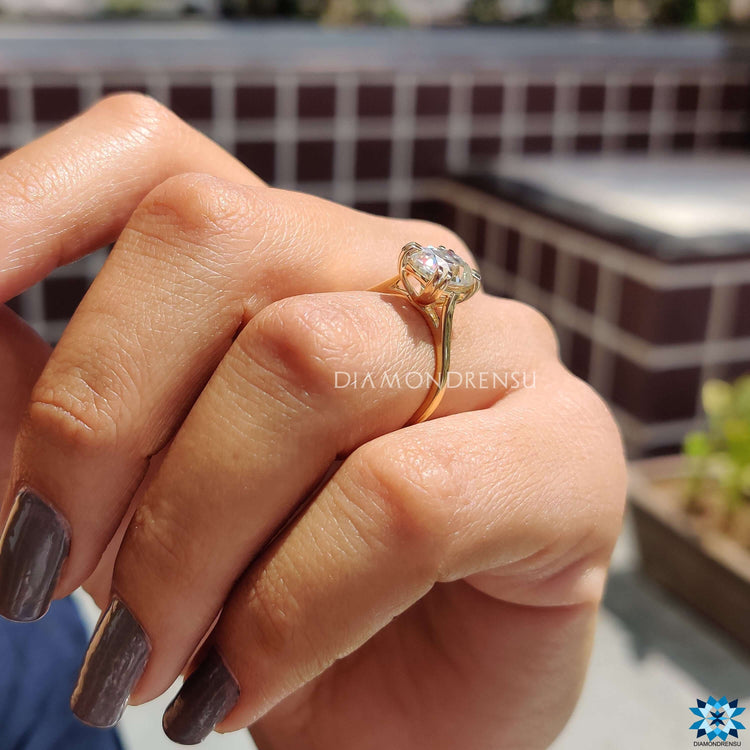 Prong set cushion moissanite ring in yellow gold.
