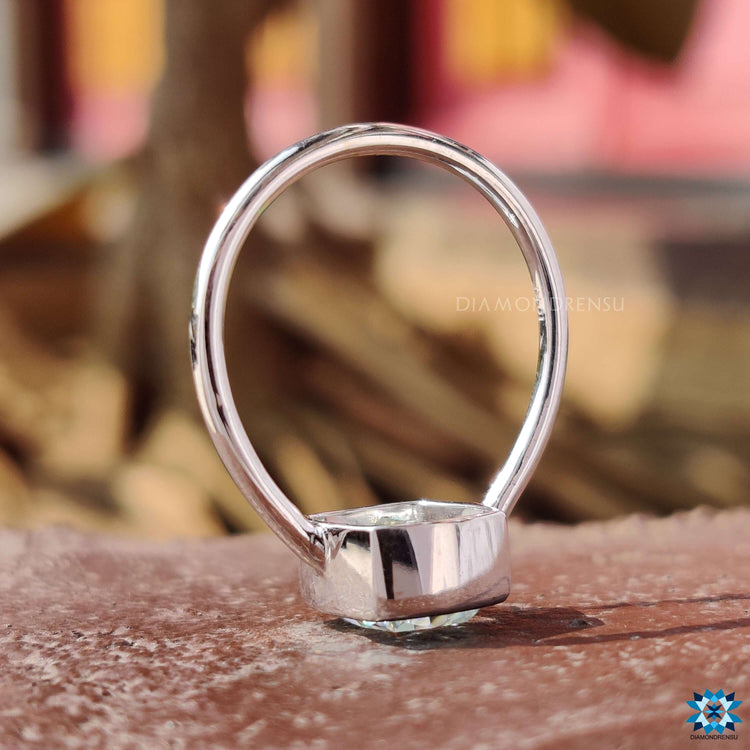 Solitaire setting ring with cushion old European cut moissanite.
