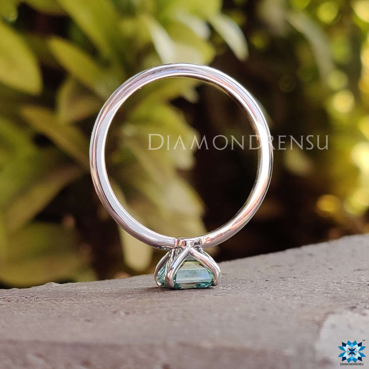 Custom engagement ring with an Asscher cut moissanite in cool tones.
