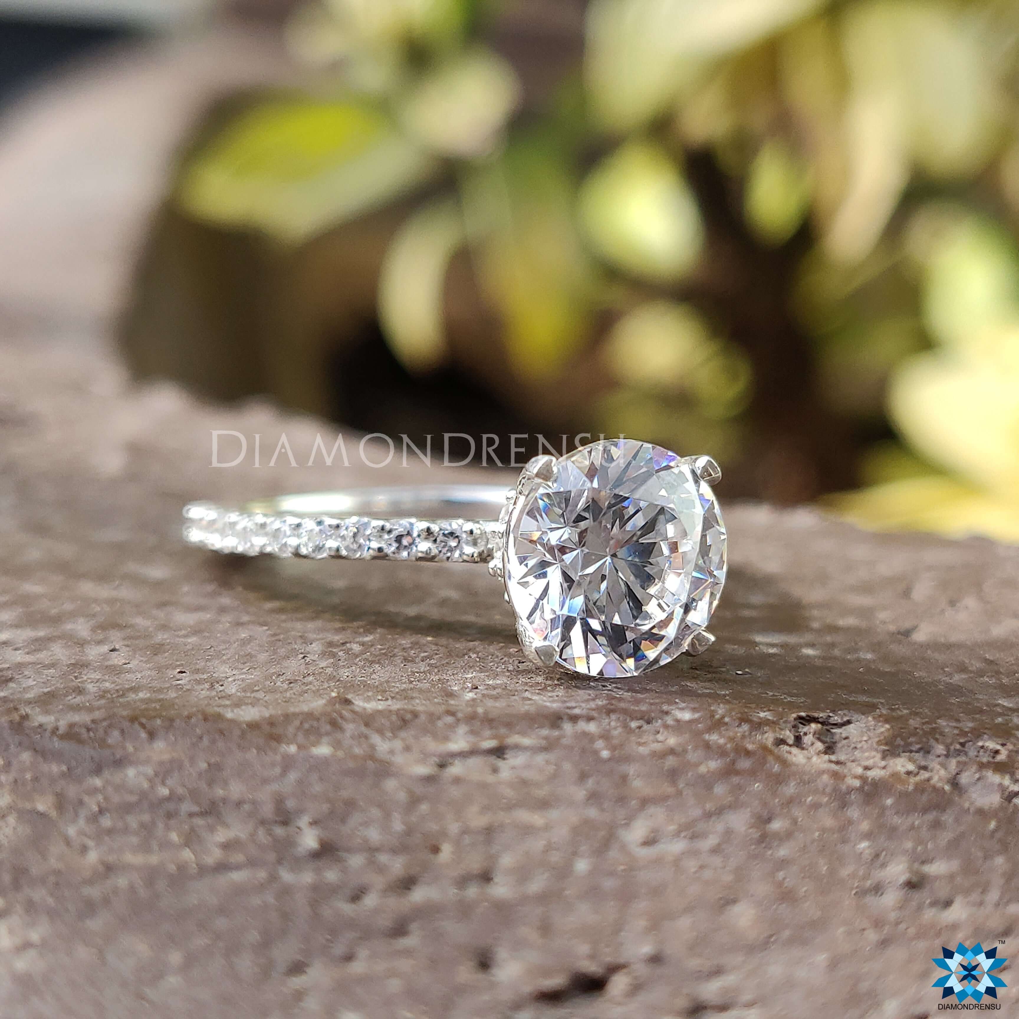 Pave setting ring with stunning moissanite stones surrounding the centrepiece.