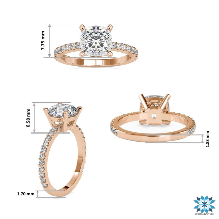 Rose gold engagement ring with cushion centre and side stones.
