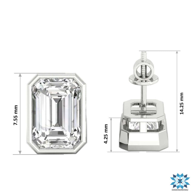 Lab grown emerald step cut diamond bezel set earrings in gold.
