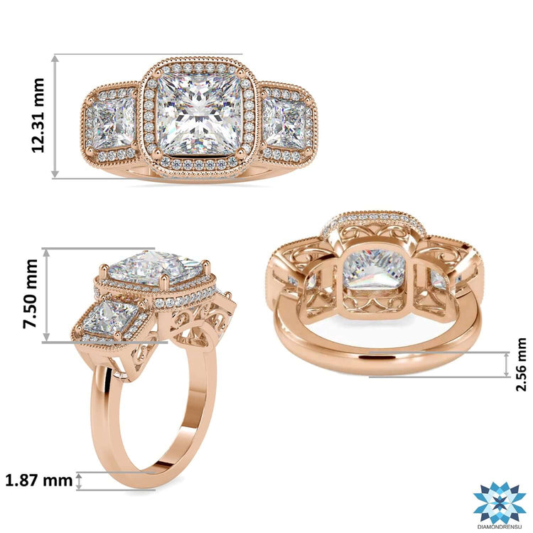 Yellow gold ring with three stone layout and milgrain detailing.
