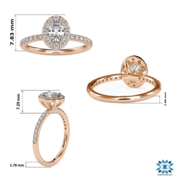 Oval diamond ring in rose gold with round halo setting.
