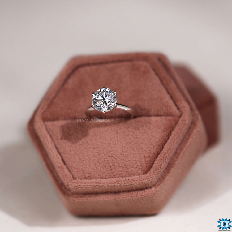 Custom engagement ring featuring round moissanite center.
