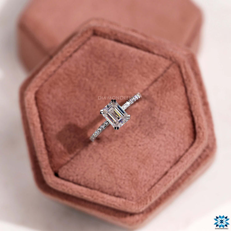 Handmade engagement ring with step cut moissanite and prong mount.
