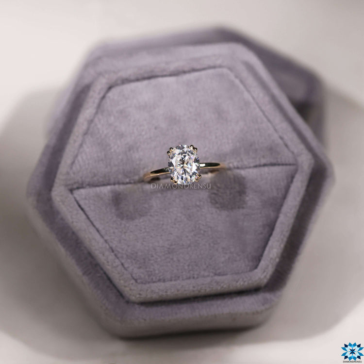 Double claw prong setting oval moissanite ring.
