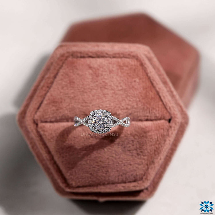Moissanite ring featuring round cut and halo design.
