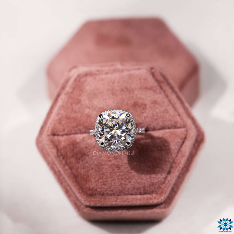 Moissanite halo ring featuring cushion center stone.
