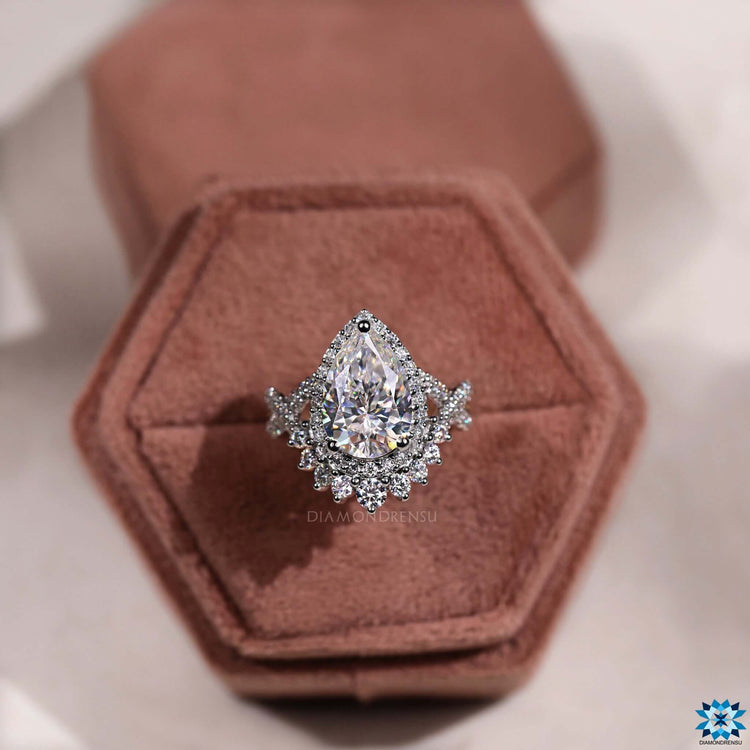 White gold ring with pear shaped moissanite center.
