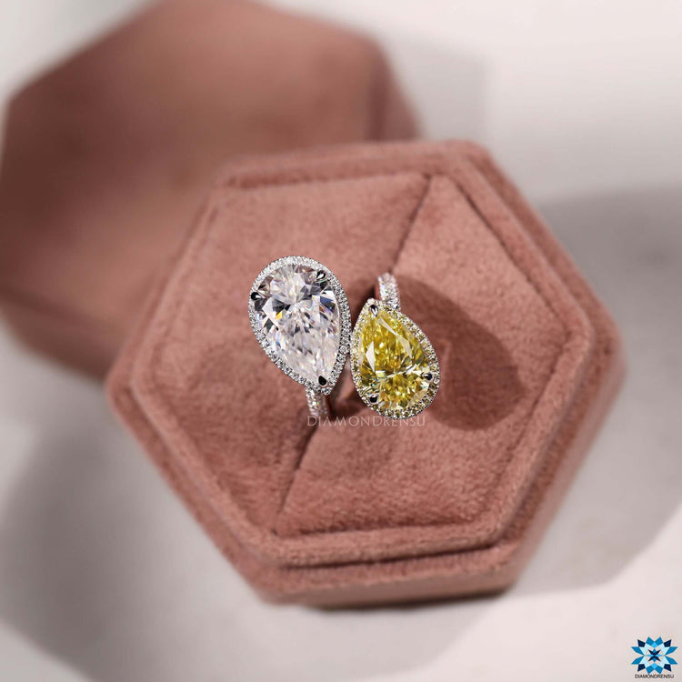 Custom two-stone ring with yellow sapphire pear and round halo moissanite.
