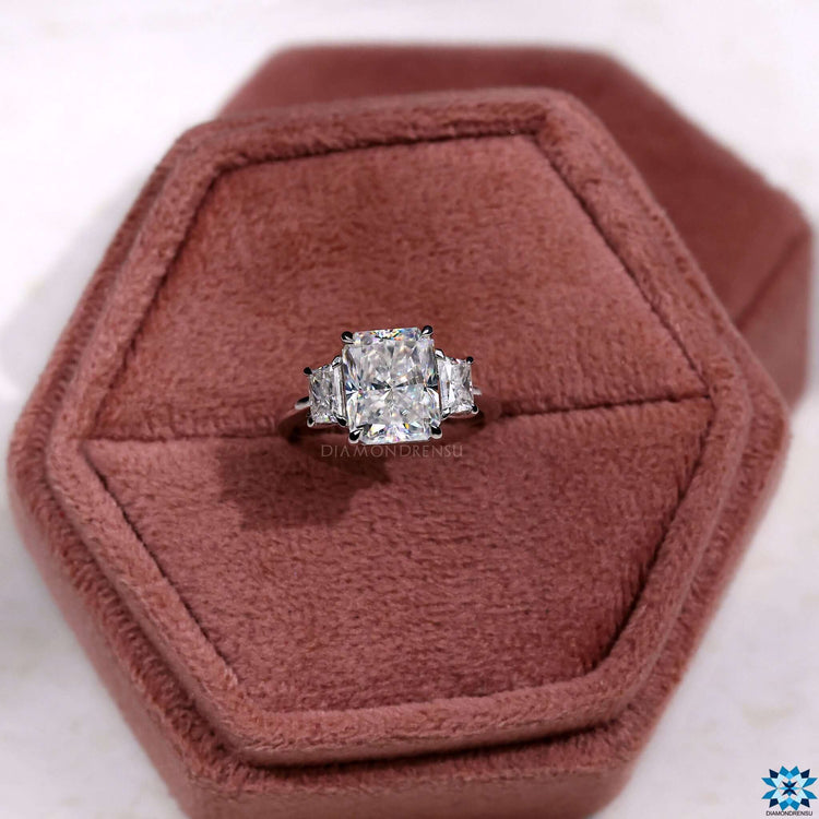 Custom engagement ring with three moissanite stones.
