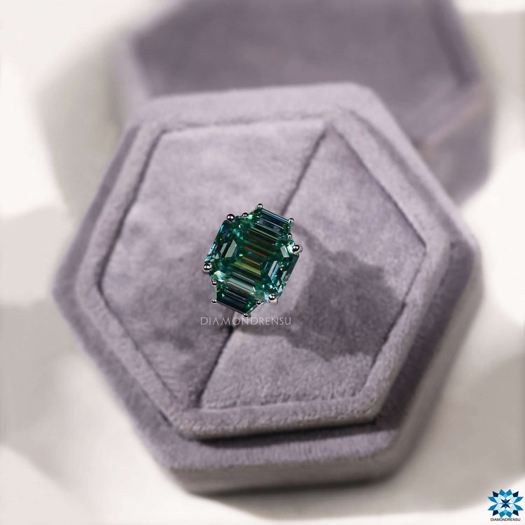 Handmade three stone ring with cyan blue moissanite.
