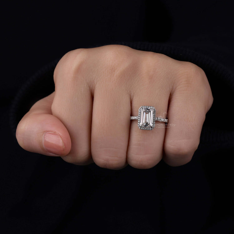 Ring with diamond and emerald featuring a unique claw prong setting
