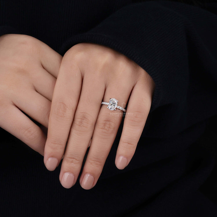 Oval diamond engagement ring crafted with pave diamonds for extra sparkle.
