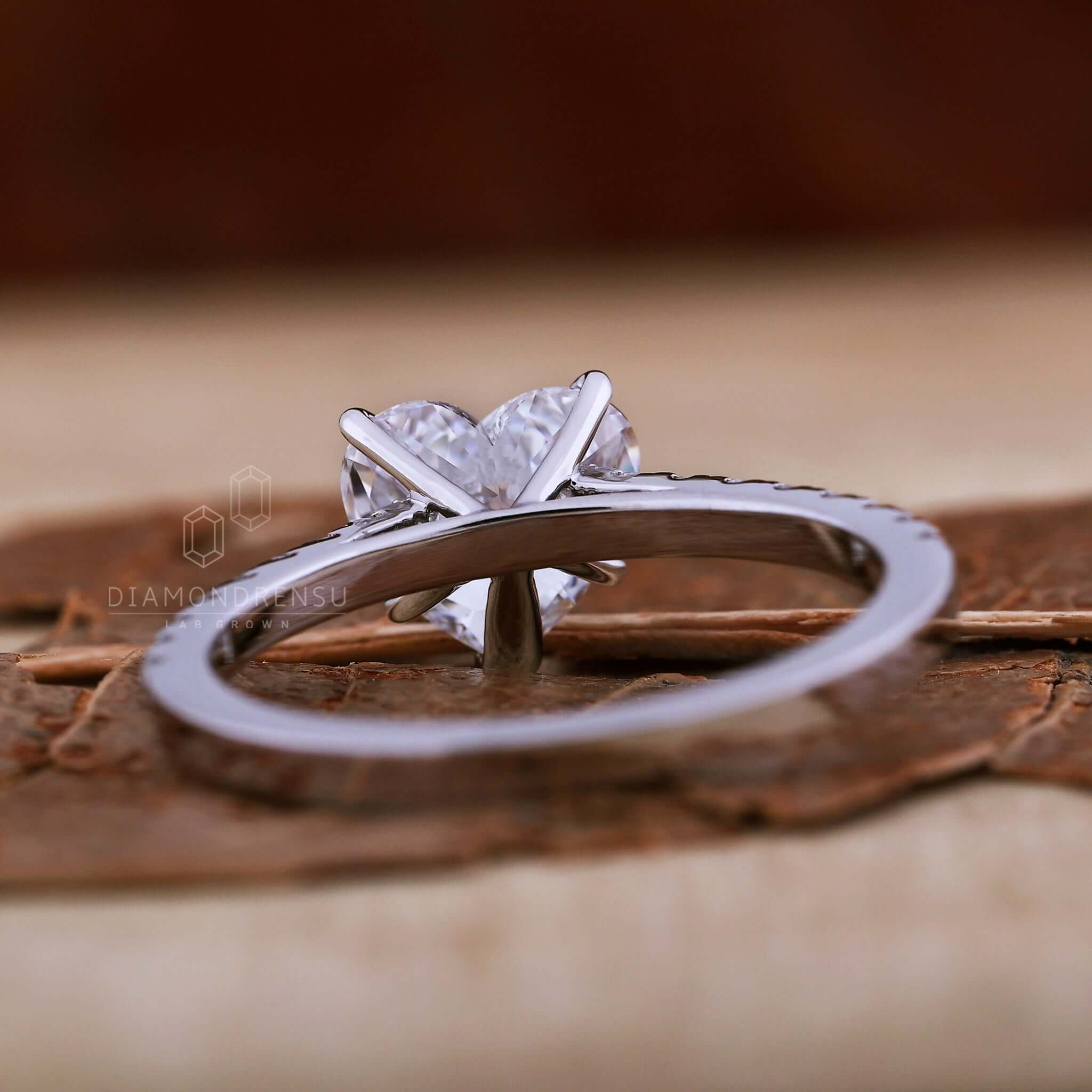 Heart shaped engagement ring with pave diamonds and a cathedral ring for a romantic touch.
