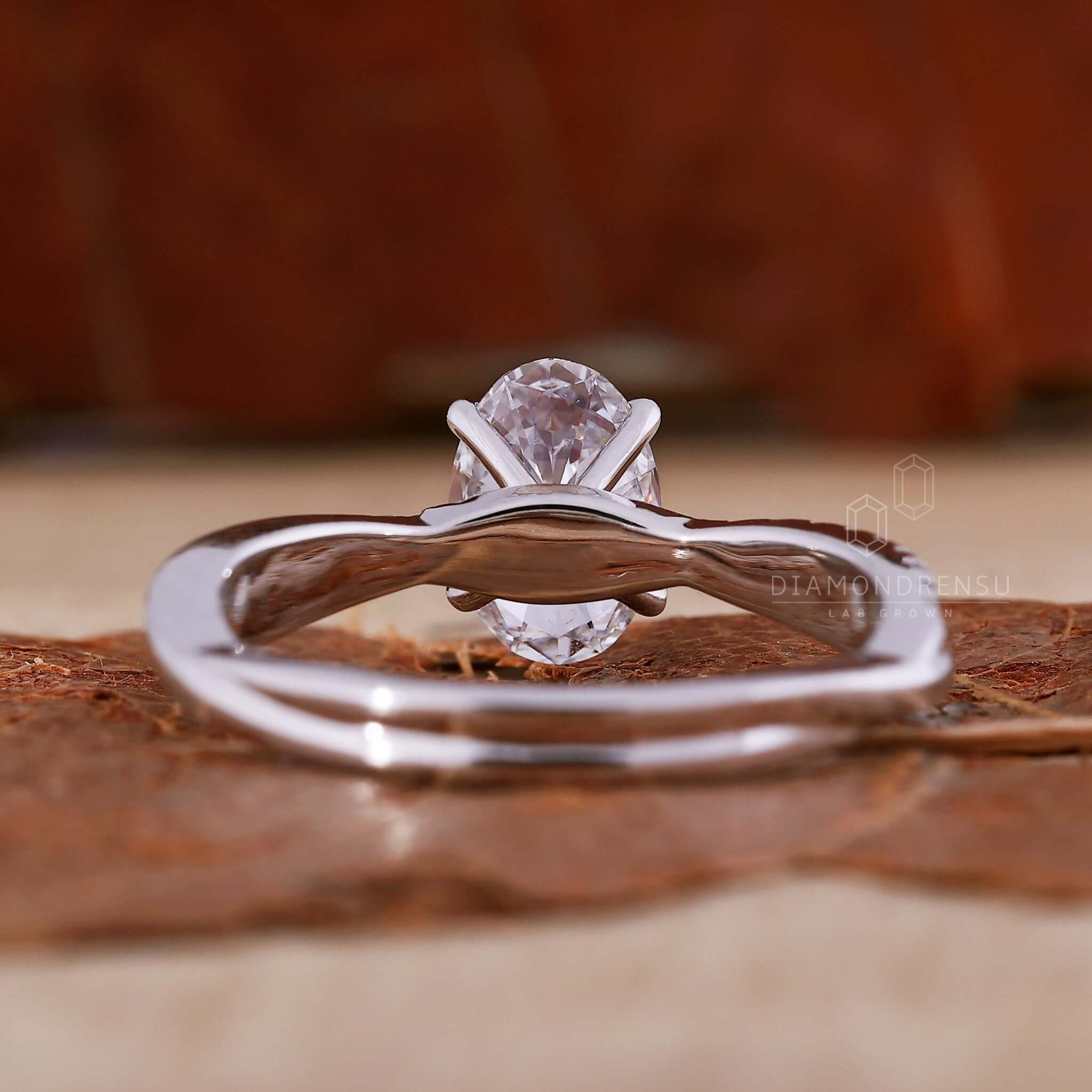 Oval engagement ring with a twisted band design and pave ring diamond details, perfect for a diamond ring UK audience.
