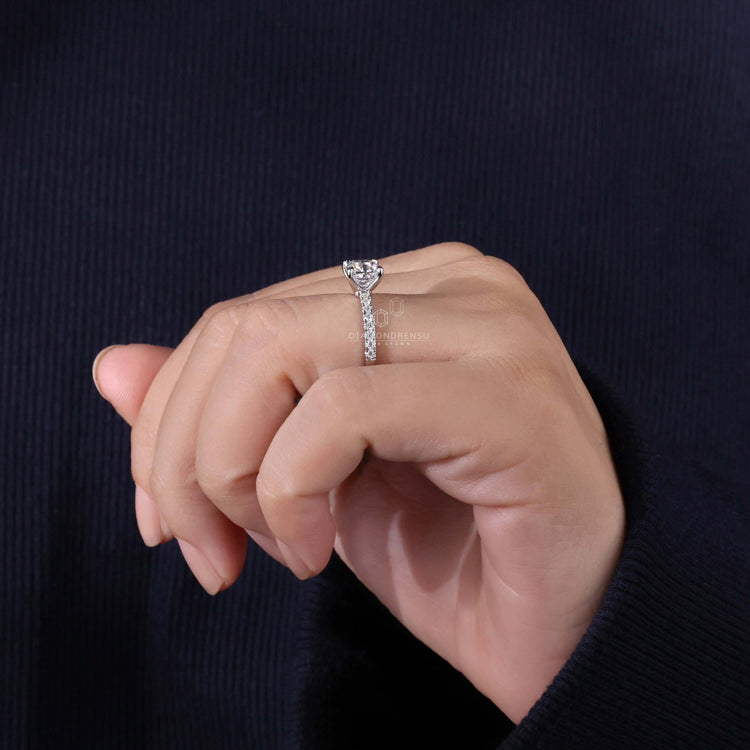 Claw prong setting cushion cut ring featuring a pave set design, perfect as a diamondrensu UK engagement ring.
