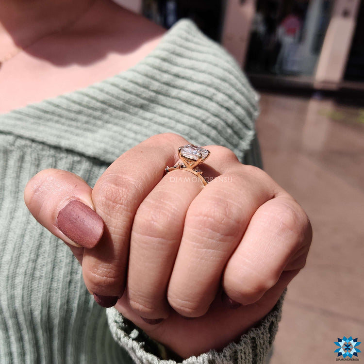 Buy moissanite ring with cushion cut and yellow gold band.
