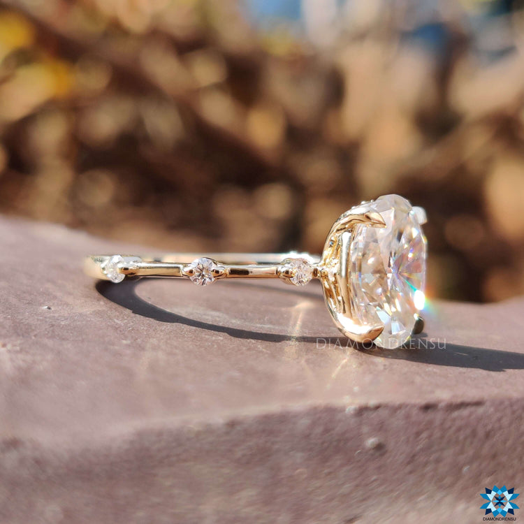 Yellow gold moissanite ring with 4 prong claw setting.
