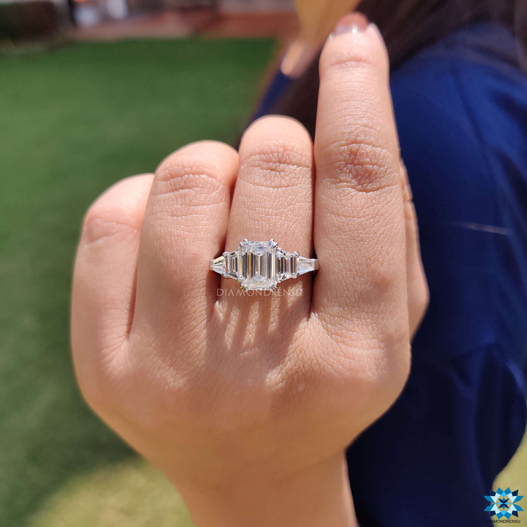 Emerald cut center stone ring with baguette accents.
