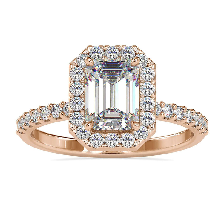 Emerald halo engagement ring with pave round cut band.
