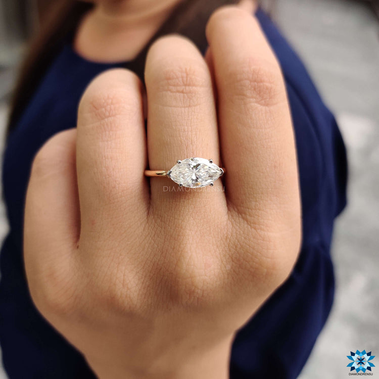 East to west marquise ring in white and rose gold.

