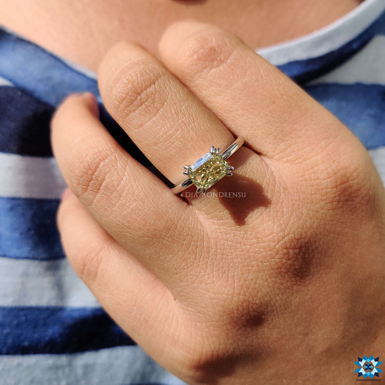Custom moissanite engagement ring with radiant cut stone.
