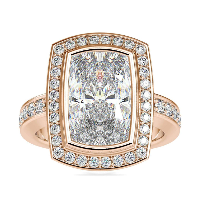 Elongated cushion cut diamond ring with halo setting.

