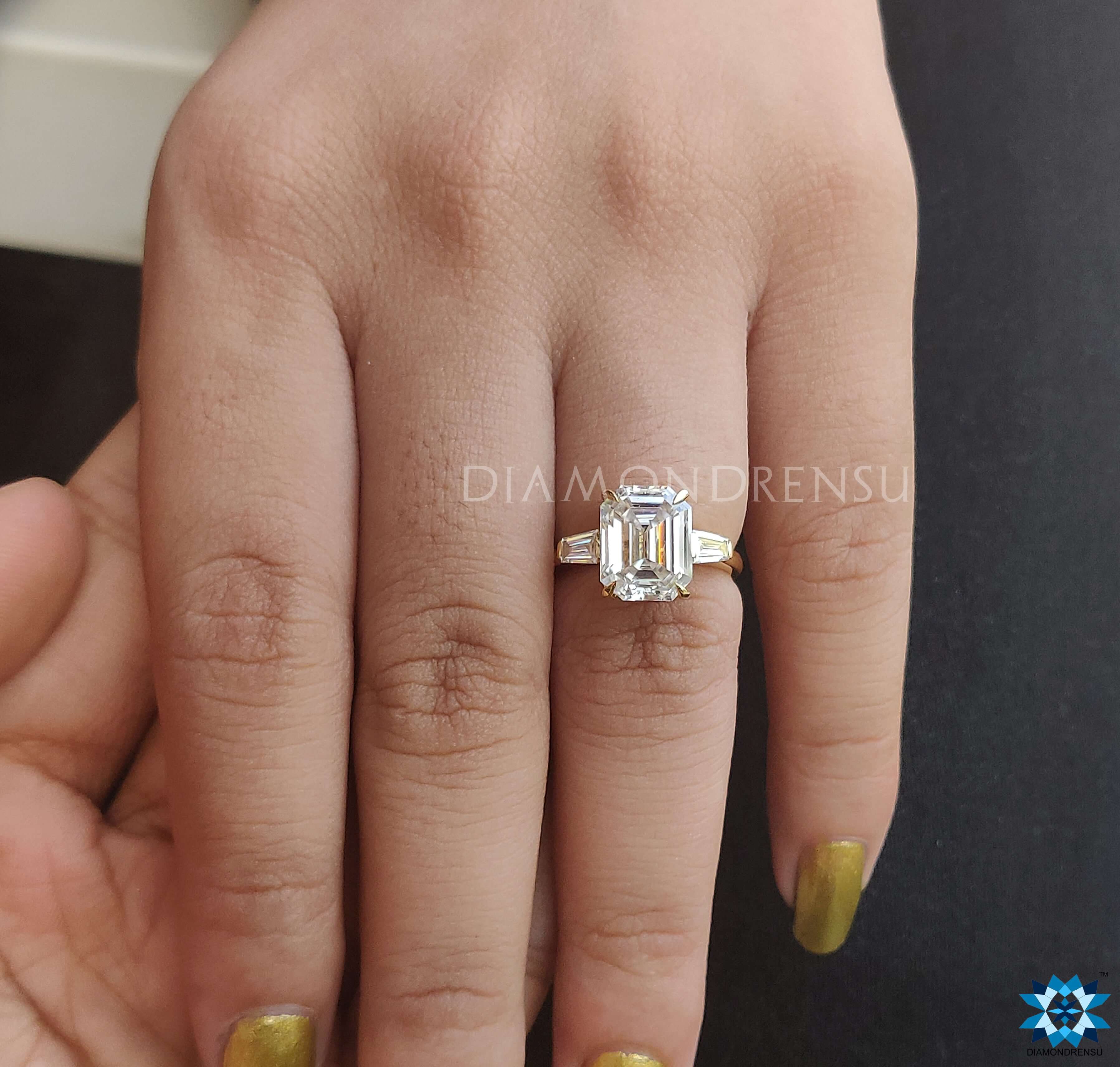 3 Stone Moissanite Ring featuring an elegant emerald cut moissanite ring.