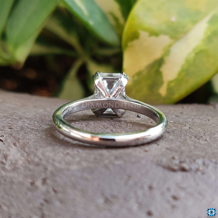 Handmade white gold ring with prong set emerald cut moissanite.
