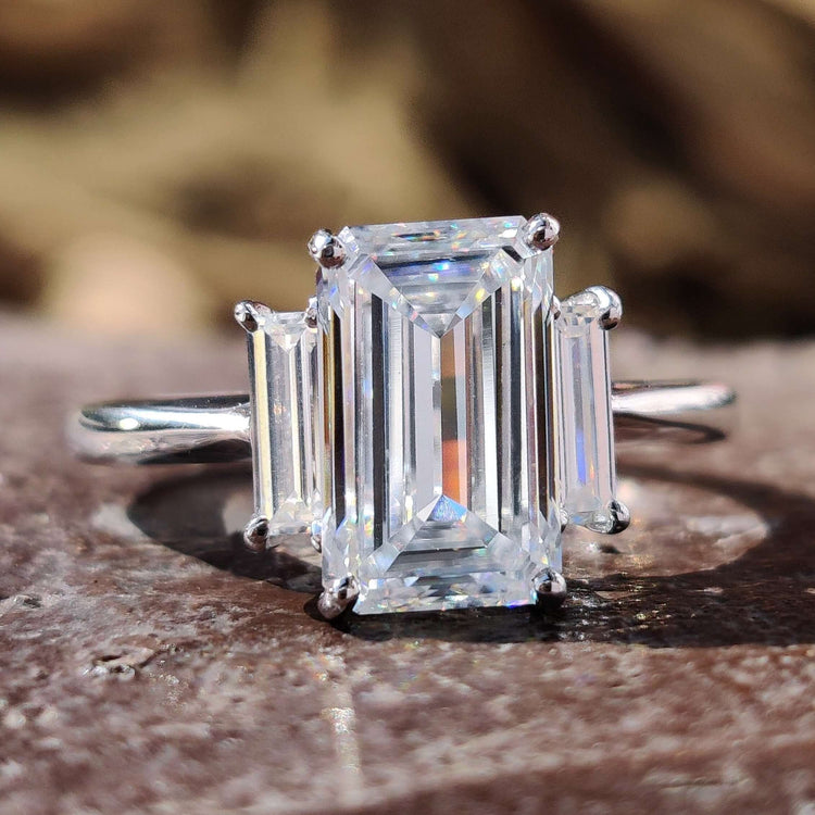 Elongated cushion cut moissanite ring set in a solitaire design.

