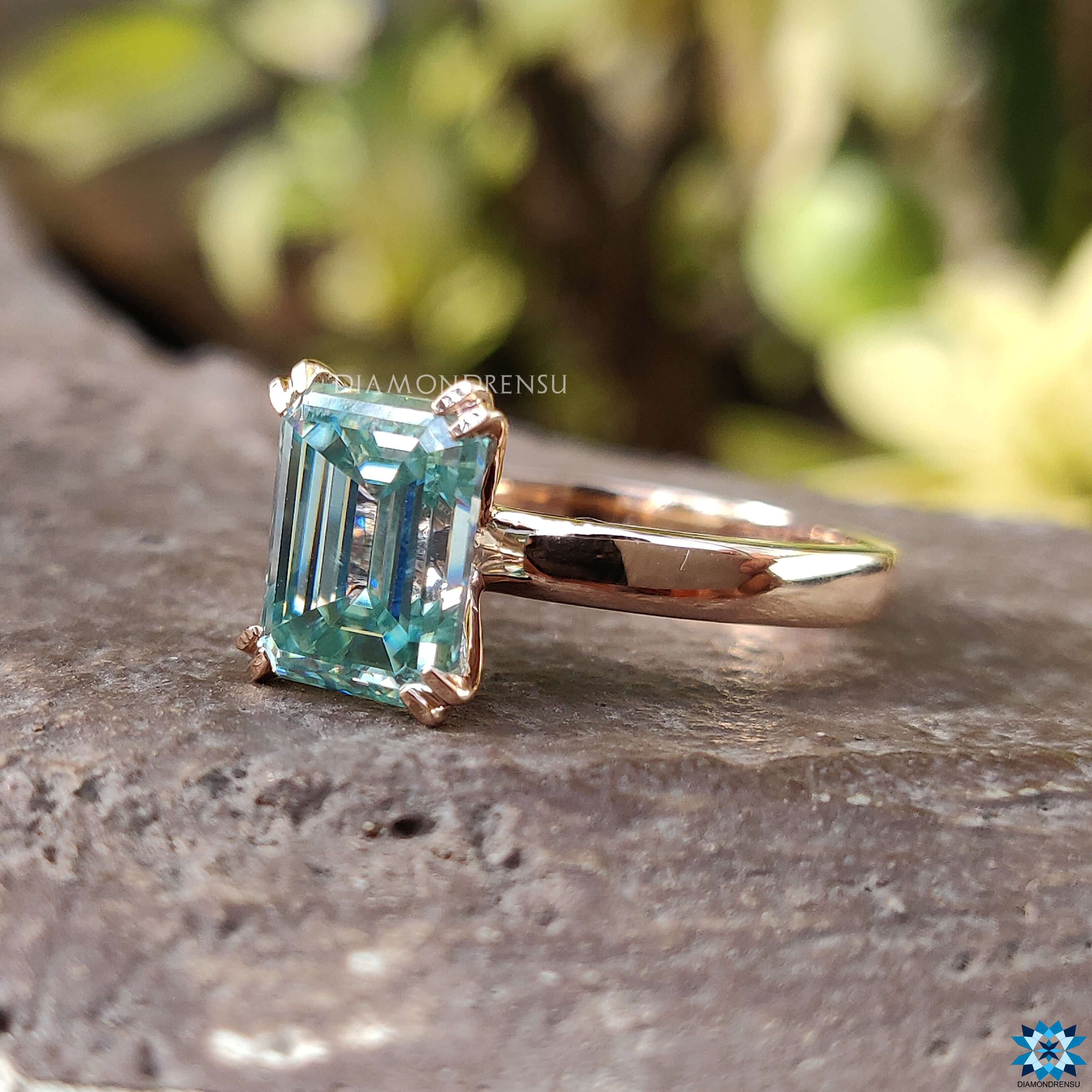 Rose gold moissanite ring showcasing a beautiful emerald cut moissanite stone.