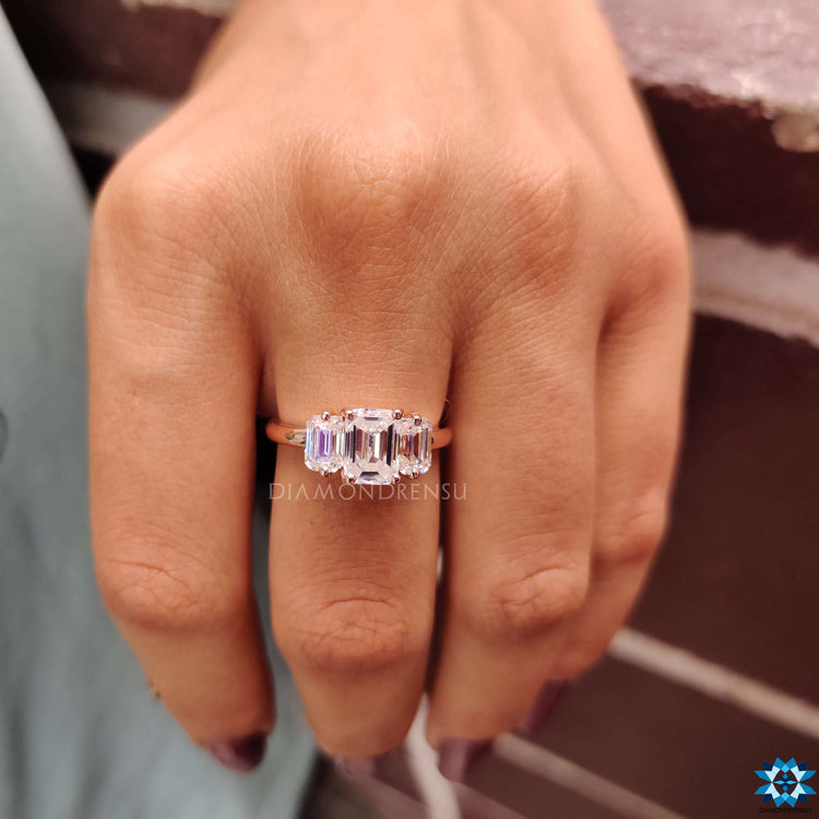 Diamondrensu UK moissanite ring with emerald side stones.
