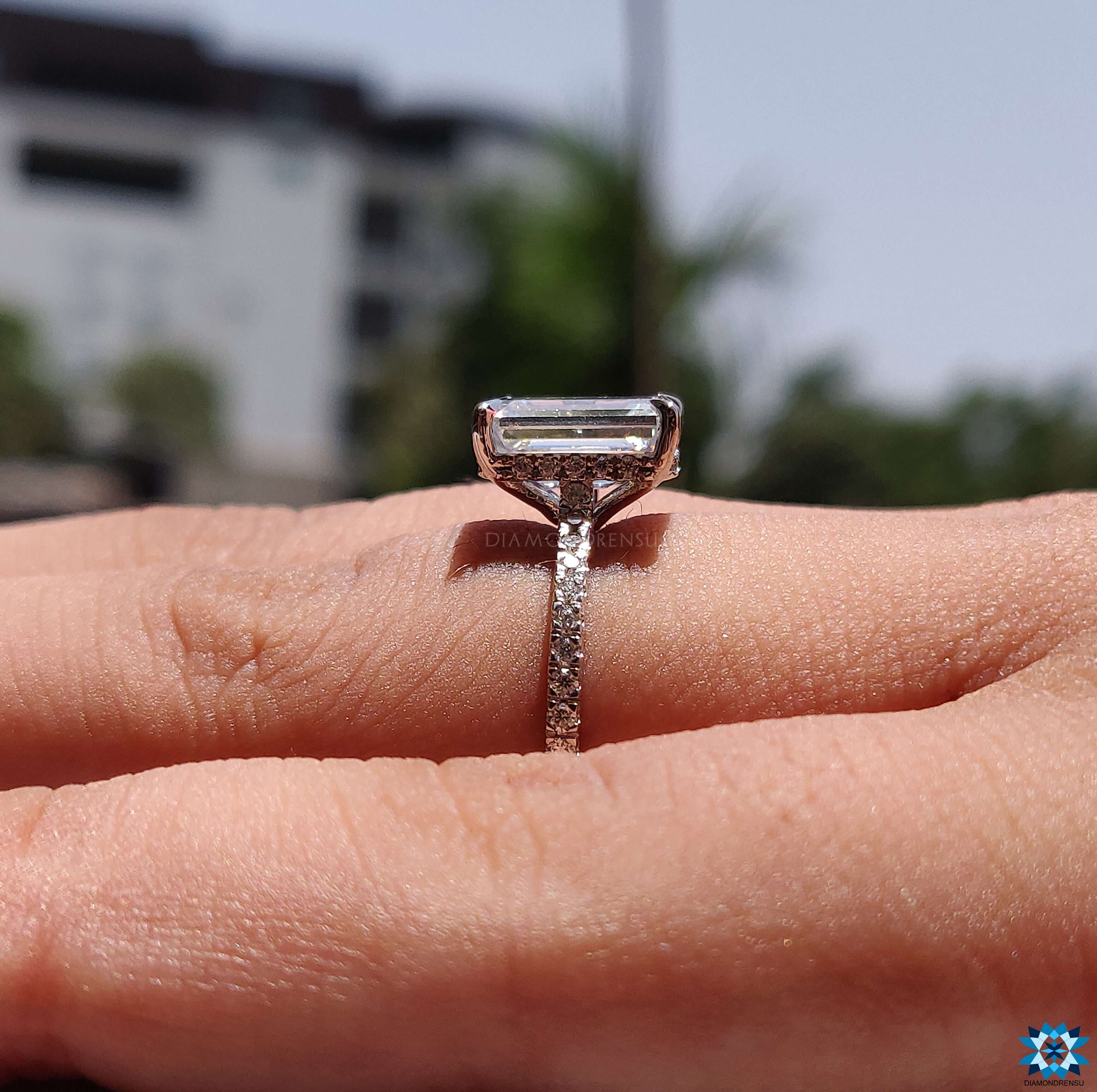 Custom ring featuring a unique emerald cut moissanite ring with a modern twist.