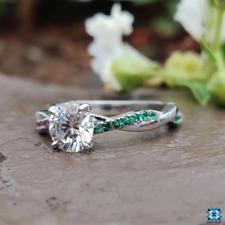 Custom white gold ring with round moissanite and mixed gem sides.
