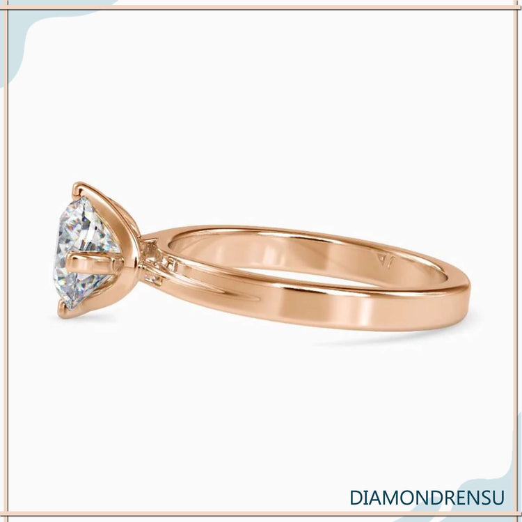 Handmade ring with round cut diamond in tab prong setting.
