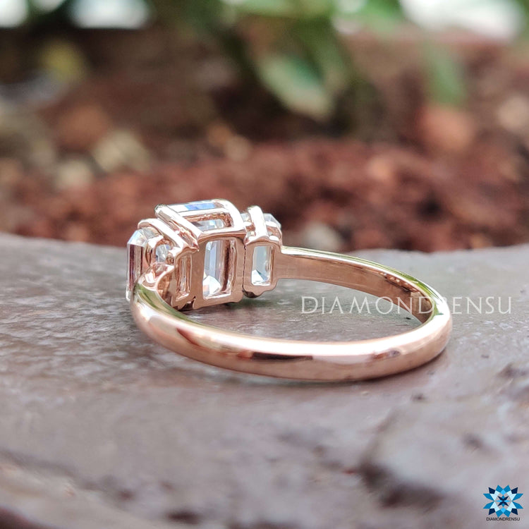 Emerald cut moissanite ring with matching side stones.
