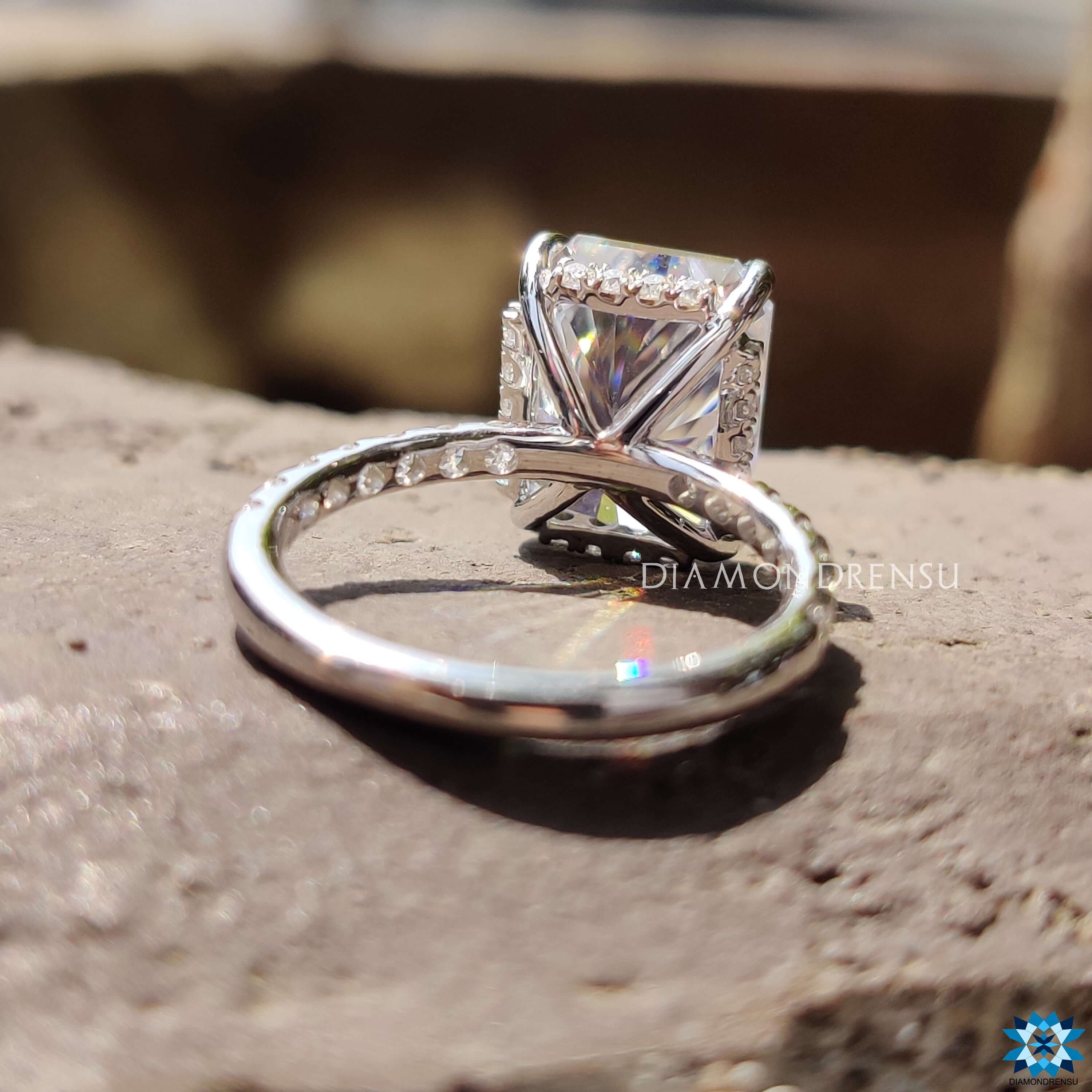 Moissanite ring UK featuring a radiant cut centre and hidden halo.