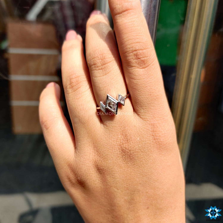 Handmade white gold ring with lozenge cut moissanite.
