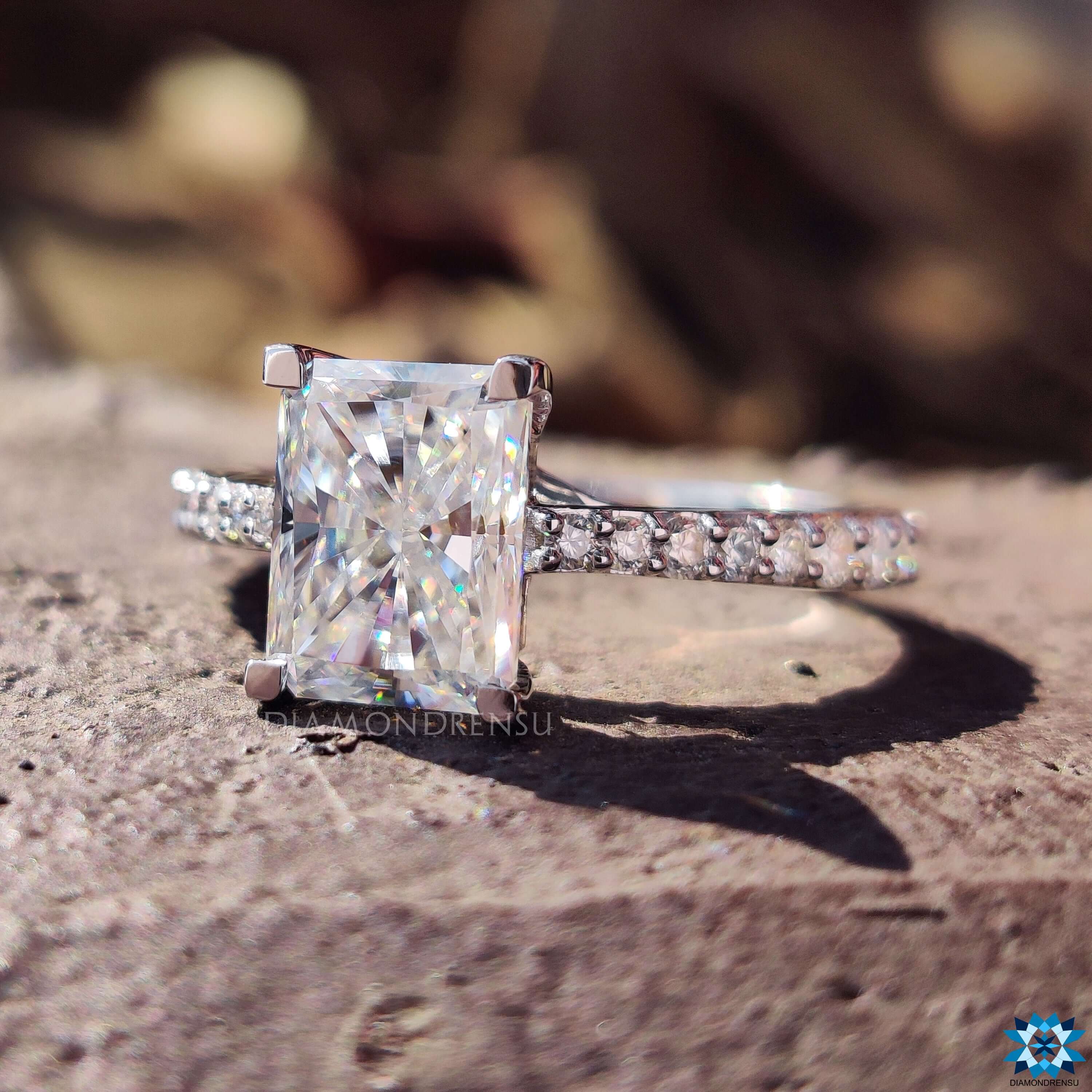 Pave band engagement ring with a radiant cut centre stone for extra brilliance.