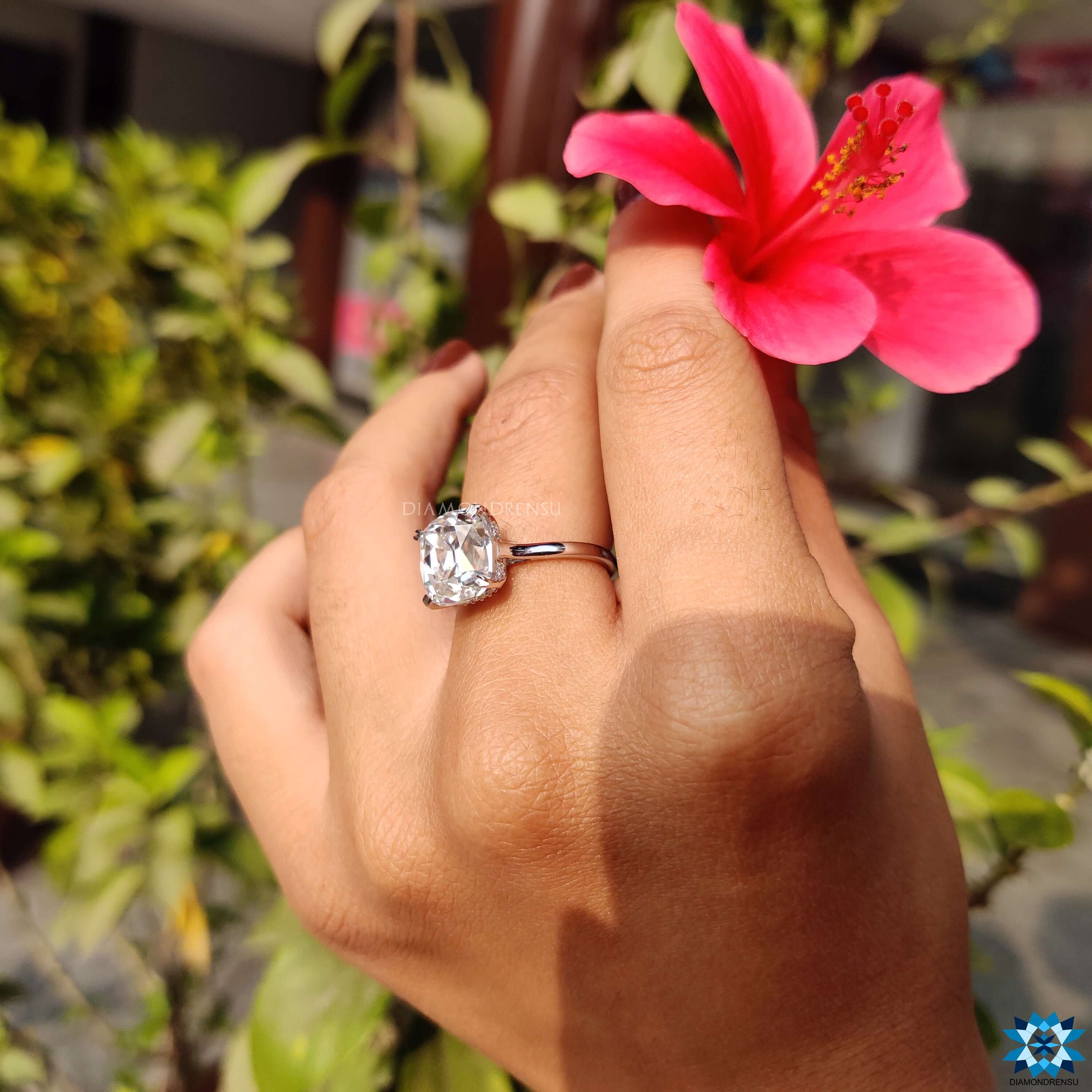 White gold moissanite ring with a stunning cushion cut engagement ring centre stone.