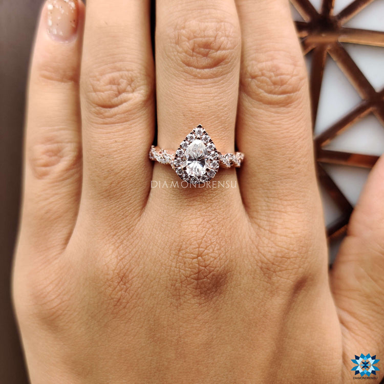 Handmade rose gold ring with pear cut and round accents.
