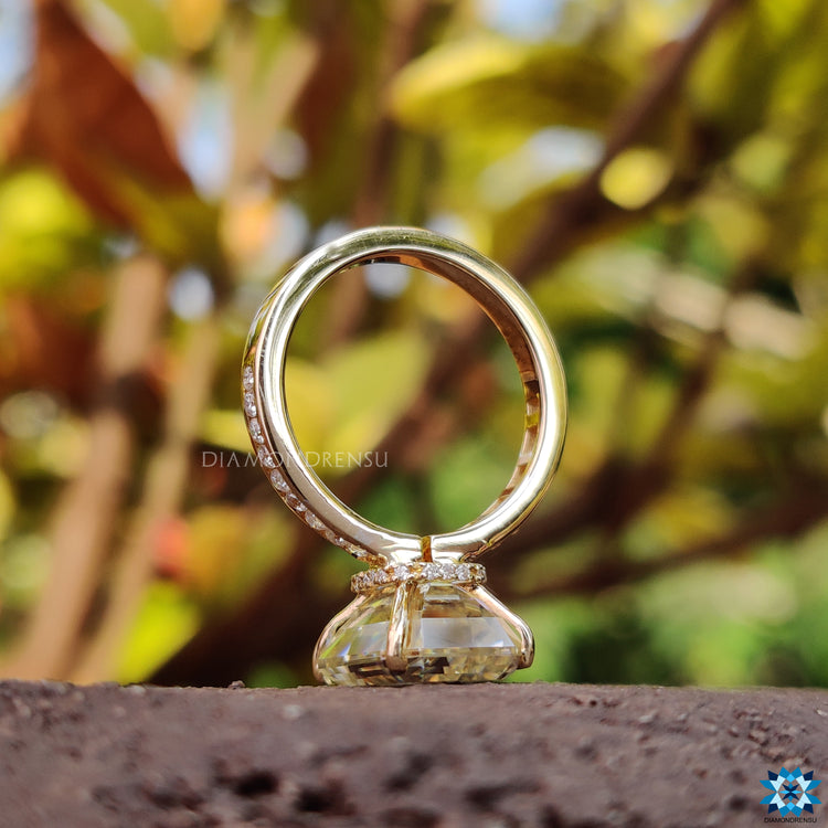 Channel set ring with emerald cut moissanite and round cut pave band.
