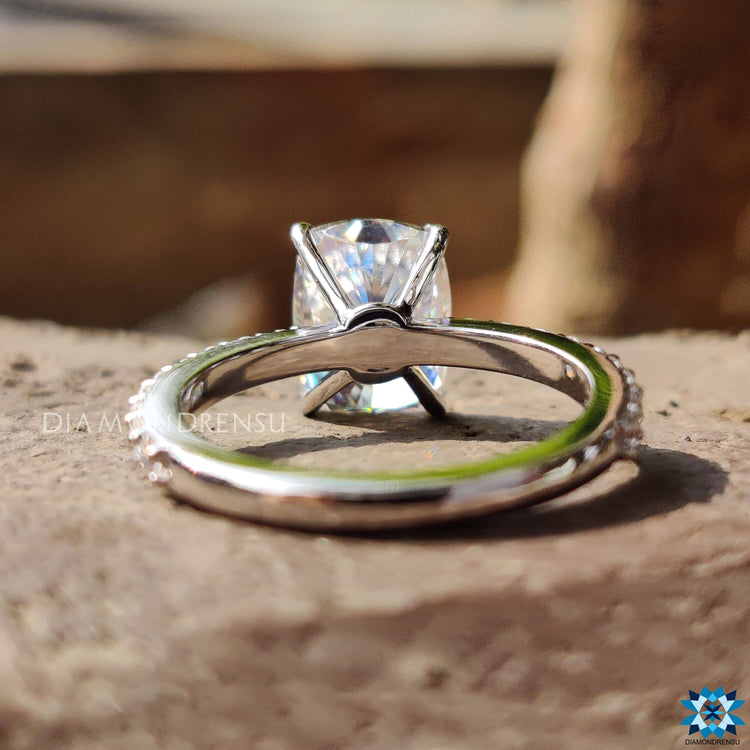 Custom moissanite engagement ring with elongated cushion cut.
